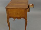 a small wooden table with a drawer on top of it