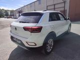 the rear end of a white suv parked in a parking lot