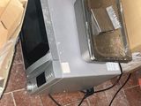 a microwave sitting on top of a box on the floor