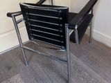 a black chair that is sitting on a hard wood floor