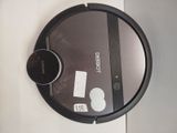 a robot that is sitting on the floor next to a mirror