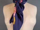 navy blue silk scarf with pink, yellow, and white floral design