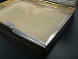 a silver case with a mirror inside of it on a table