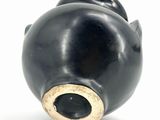 a black object with a gold ring on it