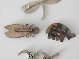four different types of brooches on a white surface