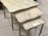 three marble top nesting tables in a room with tile flooring
