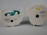 pair of white and green ceramic vases with a blue and green design