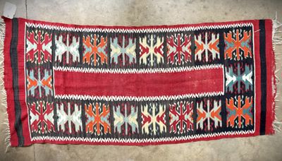 a red and black rug with a pattern on it