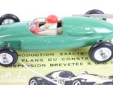 a green toy car with a red ball in it