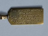 a close up of a gold plated key with writing on it