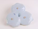 a blue flower shaped object on a white surface