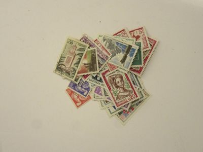 a pile of stamps on a white surface
