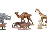 several figurines of different animals are shown on a white surface