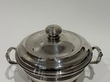silver plated casserole with handles on a white surface