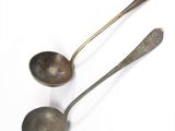 two spoons that are sitting next to each other on a table