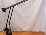 an image of a desk lamp that is on a wooden table