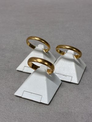 three gold rings sitting on top of a pyramid