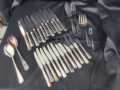 a lot of silverware on a table with a black cloth