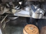 pots and pans are sitting on a shelf in a kitchen