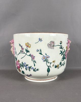 a white bowl with flowers on it sitting on a table