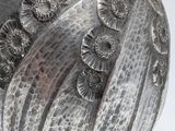 a silver vase with a flower decoration on it