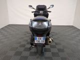 a motorcycle that is parked in a room with a checkered floor