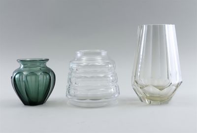three glass vases sitting next to each other on a table