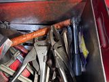 a metal tool box filled with tools on the floor