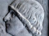 a relief of a woman with a hat on her head