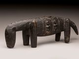 an image of a wooden elephant statue on a white surface
