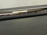 a close up of a metal object on a leather surface
