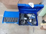a blue tool box with tools in it on the floor