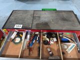 many tools in the drawer of a workbench in the garage
