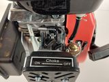 a close up of a small engine on a white surface