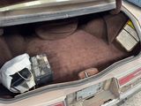 a trunk of a car with a bunch of items inside of it