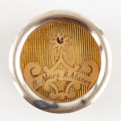 a close up of a silver and gold locke with a picture on it