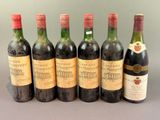 six bottles of wine are lined up on a table