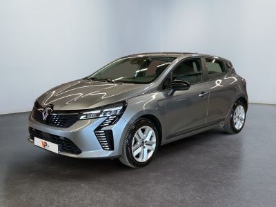 a grey car is parked in a room with a white wall