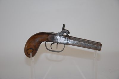 an old gun that is on display in a glass case