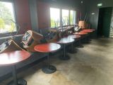 many tables and chairs lined up in a room