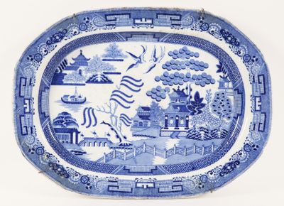a blue and white plate with a picture of a dragon on it