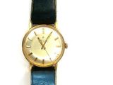 a watch that is sitting on a black leather strap