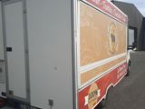 an image of a food truck parked in front of a building
