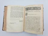 an open book on a white surface with a drawing on it