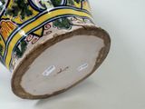 a close up of a vase on a white surface