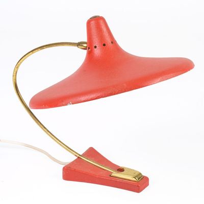 an image of a red table lamp with a gold base