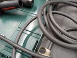 a drill and a cord in a case on a table