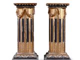 pair of antique black and gold columns on marble bases