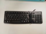 a black keyboard and mouse on a white table