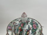 a small bowl with a lid on a white surface